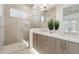 Main bathroom featuring double sink vanity, walk-in shower with glass doors, and neutral color palette at 1 Easy St # 5, Carefree, AZ 85377