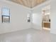 Bright main bedroom featuring tiled floors, wood plank ceiling and two windows, with an en suite bathroom at 1 Easy St # 5, Carefree, AZ 85377