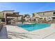 Community pool and lounge area with outdoor seating and nearby buildings under clear blue skies at 1 Easy St # 5, Carefree, AZ 85377