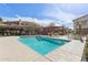 Relaxing community pool and lounge area with umbrellas and nearby seating area at 1 Easy St # 5, Carefree, AZ 85377