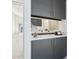 Elegant wet bar featuring a bright countertop, dark cabinetry and open view into the main bedroom at 1 Easy St # 5, Carefree, AZ 85377