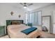 Bright bedroom with shutters, mirror, and stylish green headboard, desk and chair set at 10101 N Arabian Trl # 1005, Scottsdale, AZ 85258