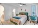 Comfortable bedroom featuring a plush green headboard, ceiling fan, and a dedicated workspace at 10101 N Arabian Trl # 1005, Scottsdale, AZ 85258