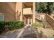 Inviting entrance with garden, well-maintained landscaping, and convenient stair access at 10101 N Arabian Trl # 1005, Scottsdale, AZ 85258