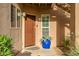 Charming entrance featuring a custom-painted door and a decorative potted plant at 10101 N Arabian Trl # 1005, Scottsdale, AZ 85258