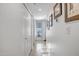 Bright hallway featuring wall decor and white doors leading to other rooms at 10101 N Arabian Trl # 1005, Scottsdale, AZ 85258
