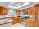 Well-equipped kitchen featuring granite countertops, stainless steel appliances, and ample cabinet space at 10101 N Arabian Trl # 1005, Scottsdale, AZ 85258