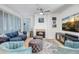 Comfortable living room featuring a fireplace, blue sofa, matching ottomans, and elegant blue armchairs at 10101 N Arabian Trl # 1005, Scottsdale, AZ 85258