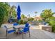 Relaxing poolside patio with comfortable seating, lush landscaping, and a view of the community pool and spa at 10101 N Arabian Trl # 1005, Scottsdale, AZ 85258