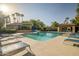 Sparkling swimming pool featuring lounge chairs, umbrellas, and lush landscaping in a resort-style community at 10101 N Arabian Trl # 1005, Scottsdale, AZ 85258