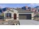 Charming single-story home featuring desert landscaping, a two-car garage, and mountain views at 10544 W Bloch Rd, Tolleson, AZ 85353