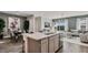 Open-concept layout featuring kitchen island with sink and view of living and dining areas at 10544 W Bloch Rd, Tolleson, AZ 85353