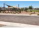 Community playground with a shaded picnic area and play structures surrounded by lush landscaping at 10544 W Bloch Rd, Tolleson, AZ 85353