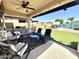 Relaxing covered patio with comfortable seating area overlooking the backyard pool at 11121 E Sombra Ave, Mesa, AZ 85212