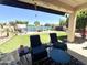Comfortable covered patio with backyard views of the pool and landscaped yard at 11121 E Sombra Ave, Mesa, AZ 85212