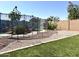 Fenced backyard featuring a pool with rock features, gravel and artificial grass at 11121 E Sombra Ave, Mesa, AZ 85212