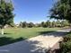 Expansive community green space with walking path and views of neighborhood homes at 11121 E Sombra Ave, Mesa, AZ 85212