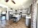 Bright, airy kitchen with gray cabinetry, a center island with seating, stainless steel appliances, and sliding glass doors to patio at 11121 E Sombra Ave, Mesa, AZ 85212