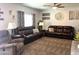 Comfortable living room with plush seating, ceiling fan, carpeting, neutral walls, and patterned drapes at 11121 E Sombra Ave, Mesa, AZ 85212