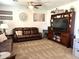 Comfortable living room with plush seating, ceiling fan, carpeting, neutral walls, and a large television and display cabinet at 11121 E Sombra Ave, Mesa, AZ 85212