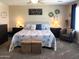 Inviting main bedroom boasts a soft color palette, carpeted floors, and warm lighting at 11121 E Sombra Ave, Mesa, AZ 85212