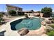 Backyard swimming pool with a rock waterfall feature and ample patio space at 11121 E Sombra Ave, Mesa, AZ 85212