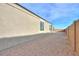 Gravel side yard with minimal landscaping and fencing, providing a sense of privacy at 1127 E Tyler Ln, Casa Grande, AZ 85122