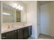 Bathroom featuring a double sink vanity with black cabinets and modern fixtures at 1127 E Tyler Ln, Casa Grande, AZ 85122