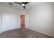 Comfortable bedroom with carpet, ceiling fan, closet, and a view to the hallway at 1127 E Tyler Ln, Casa Grande, AZ 85122