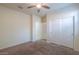 A cozy bedroom featuring neutral walls and carpet, with double closet and ceiling fan for comfort at 1127 E Tyler Ln, Casa Grande, AZ 85122