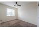 Bedroom with carpet, ceiling fan, and window, offering ample natural light at 1127 E Tyler Ln, Casa Grande, AZ 85122