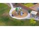 Aerial view of a community playground and picnic area with walking path and grassy area at 1127 E Tyler Ln, Casa Grande, AZ 85122