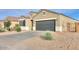 View of home's exterior with gravel landscaping and paved driveway and walkway at 1127 E Tyler Ln, Casa Grande, AZ 85122