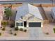 Inviting single-story home featuring a well-manicured yard and a spacious two-car garage at 1127 E Tyler Ln, Casa Grande, AZ 85122
