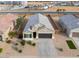 Inviting single-story home featuring a well-manicured yard and a spacious two-car garage at 1127 E Tyler Ln, Casa Grande, AZ 85122