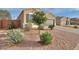Well-maintained exterior with gravel landscaping, complemented by mature trees and shrubs at 1127 E Tyler Ln, Casa Grande, AZ 85122