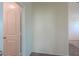 Hallway with neutral carpeting and white door, offers access to the other rooms in the home at 1127 E Tyler Ln, Casa Grande, AZ 85122