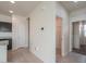 This hallway leads from the kitchen to a bedroom with carpeting at 1127 E Tyler Ln, Casa Grande, AZ 85122