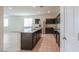 This spacious open-concept kitchen features a central island, stainless steel appliances, and dark cabinetry at 1127 E Tyler Ln, Casa Grande, AZ 85122