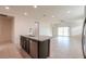 This large kitchen features an island with dark cabinets, stainless appliances, and granite countertops at 1127 E Tyler Ln, Casa Grande, AZ 85122