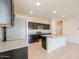 This bright kitchen offers stainless steel appliances, dark cabinets and a central island at 1127 E Tyler Ln, Casa Grande, AZ 85122