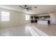 Spacious open floor plan with tile flooring leading to the kitchen with stainless steel appliances and island at 1127 E Tyler Ln, Casa Grande, AZ 85122