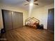 Bedroom with wood-look floors, sliding door closet and whimsical bed frame at 12937 W Calle De Sol --, Peoria, AZ 85383