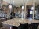 Spacious kitchen island featuring granite counters, stainless steel appliances, and modern lighting at 12937 W Calle De Sol --, Peoria, AZ 85383