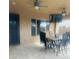 Inviting outdoor patio featuring tile flooring, a ceiling fan, a large flat screen tv and a dining table with chairs at 12937 W Calle De Sol --, Peoria, AZ 85383