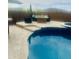 Backyard pool with artificial turf, built-in spa, and full poolside kitchen with seating area at 12937 W Calle De Sol --, Peoria, AZ 85383