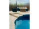 Inviting pool area with elegant stone patio and outdoor seating, perfect for relaxation and entertainment at 12937 W Calle De Sol --, Peoria, AZ 85383