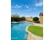 Serene swimming pool with meticulously maintained artificial turf at 12937 W Calle De Sol --, Peoria, AZ 85383