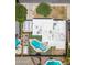 An aerial view displays a property featuring a pristine pool, a boat, and a well-maintained roof with adjacent greenery at 1308 S Spur --, Mesa, AZ 85204
