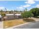 Aerial view of home's front exterior with a spacious driveway, mature landscaping, and a serene neighborhood setting at 1308 S Spur --, Mesa, AZ 85204